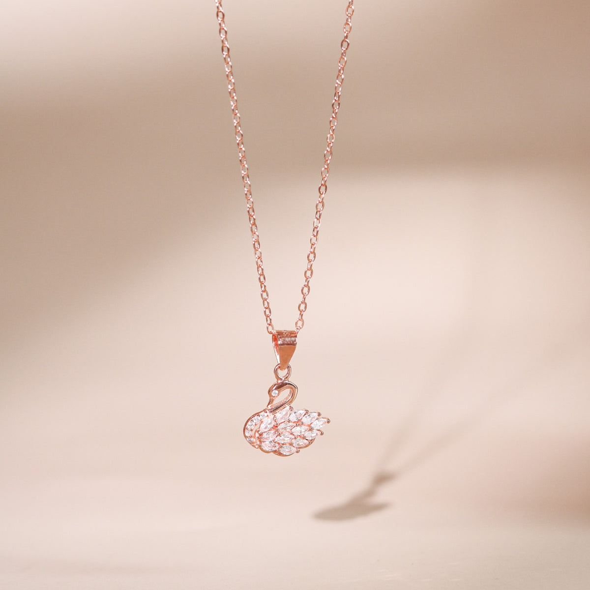 Eleanor women's silver necklace, plated with 18K rose gold and platinum, features a swan pendant, exuding timeless elegance