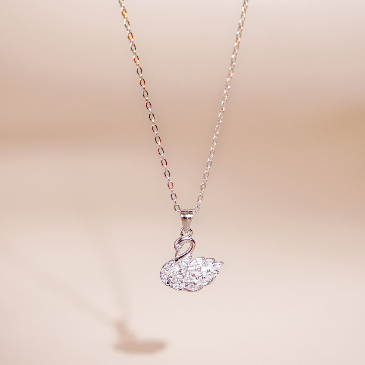 Eleanor women's silver necklace, plated with 18K rose gold and platinum, features a swan pendant, exuding timeless elegance