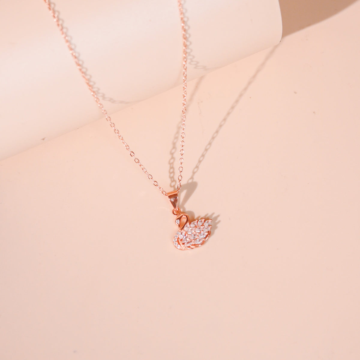 Eleanor women's silver necklace, plated with 18K rose gold and platinum, features a swan pendant, exuding timeless elegance