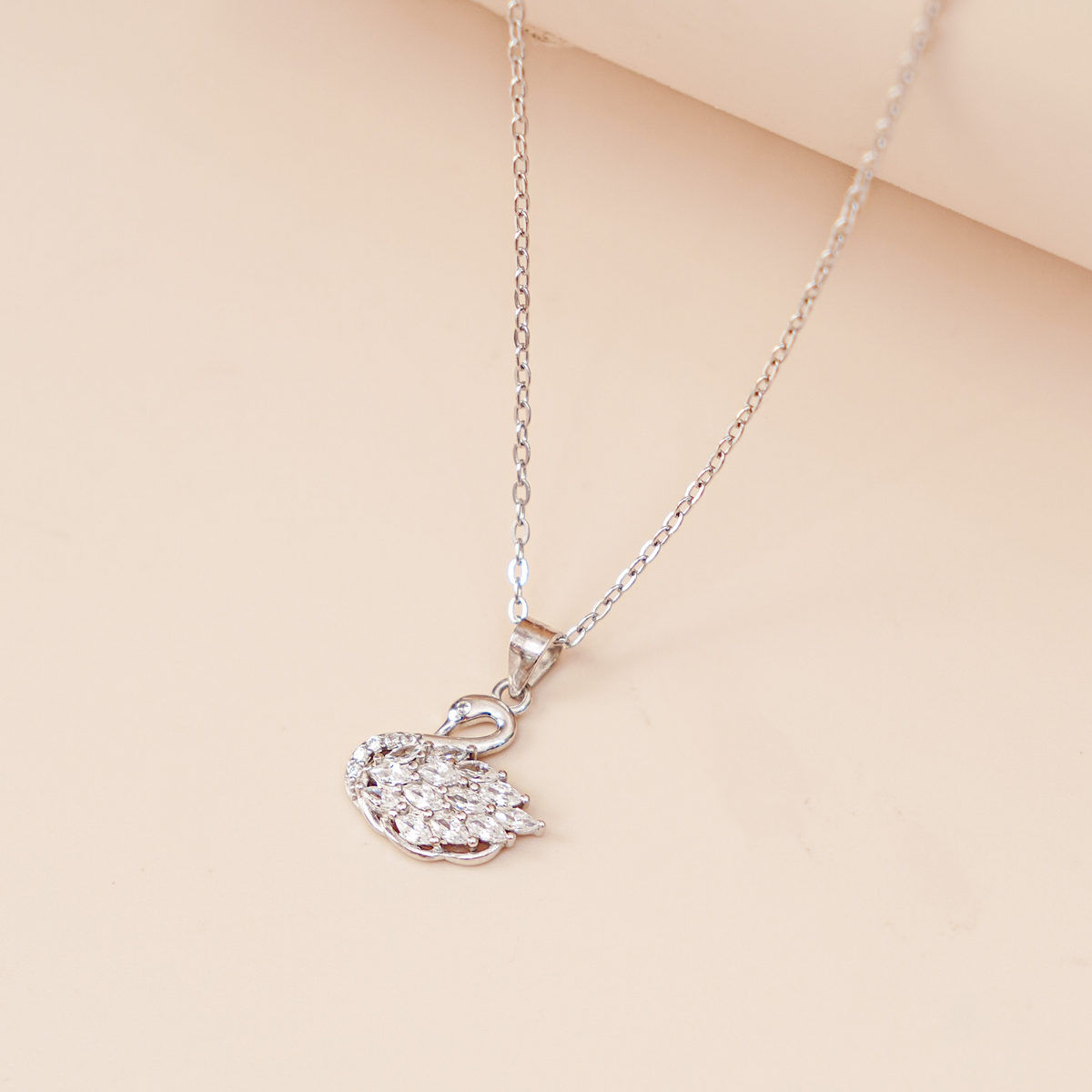Eleanor women's silver necklace, plated with 18K rose gold and platinum, features a swan pendant, exuding timeless elegance