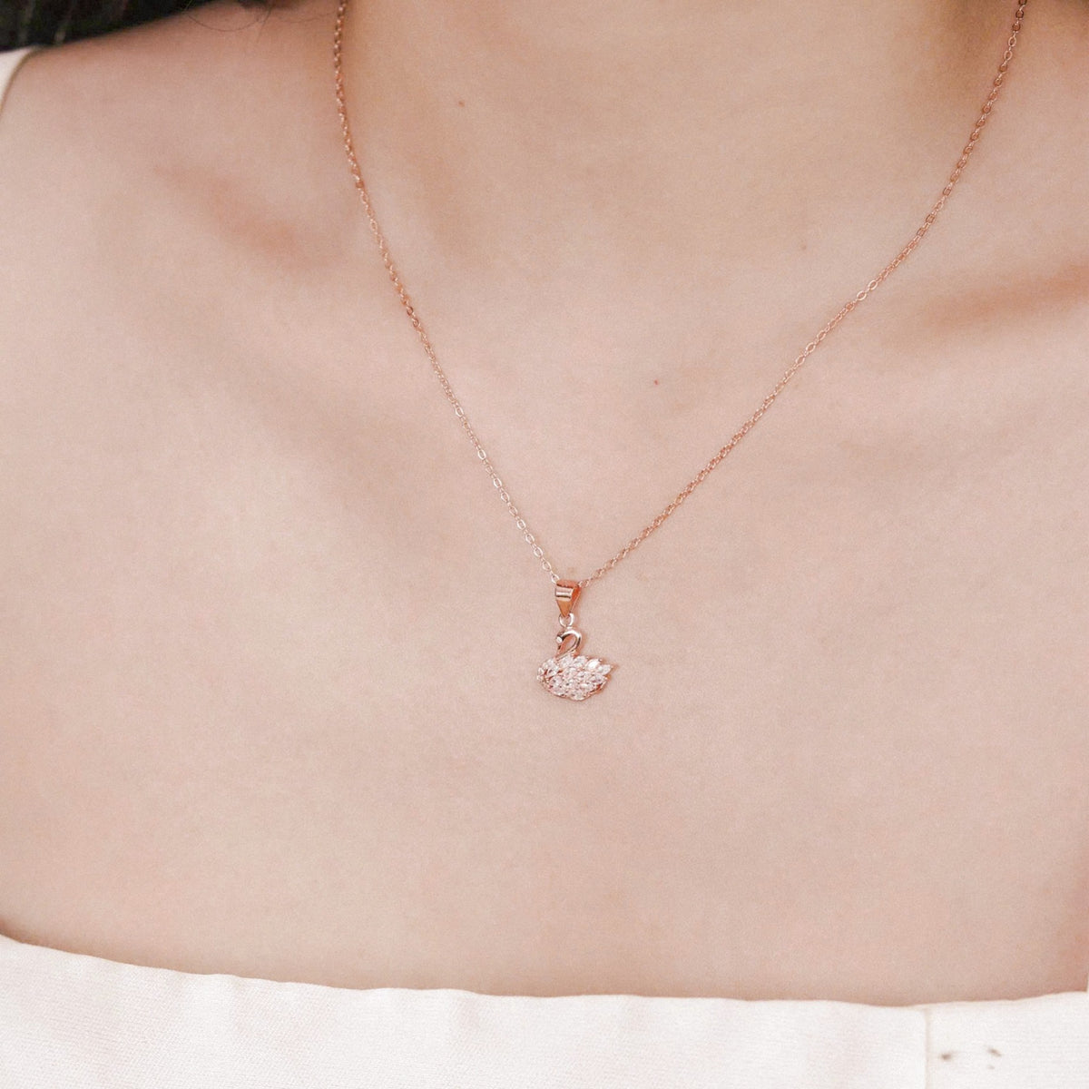 Eleanor women's silver necklace, plated with 18K rose gold and platinum, features a swan pendant, exuding timeless elegance