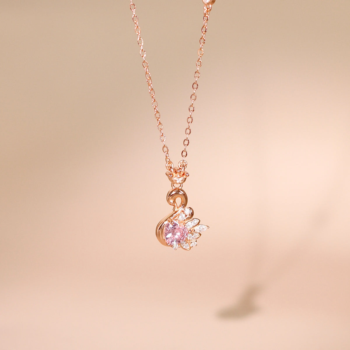 Fiona women's silver necklace, plated with 18K rose gold, features an elegant and proud swan pendant