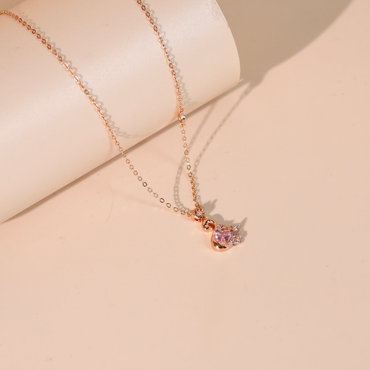 Fiona women's silver necklace, plated with 18K rose gold, features an elegant and proud swan pendant