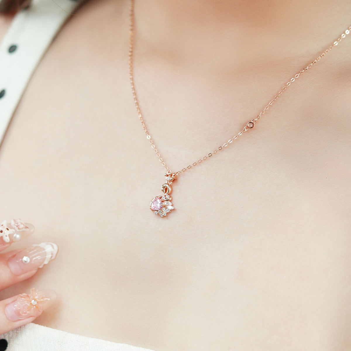 Fiona women's silver necklace, plated with 18K rose gold, features an elegant and proud swan pendant